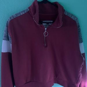 It is pink white and grey with a zipper.